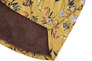 Close-up detail of a floral print jacket with wooden buttons and warm fleece lining