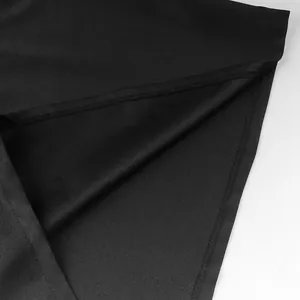 Macro detail of the high-quality black fabric and hem stitching on the medieval robe