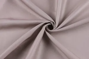 Close-up view of the soft taupe woven fabric texture and drape of this retro summer dress