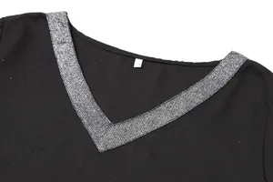 Detail view of a black V-neck dress with shiny silver sequin trim and a size M label.