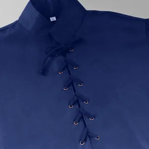 Detail of navy blue medieval tunic featuring front lace-up design and fabric texture.