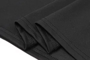 Detail shot showing the neat double-row stitching on the hem of the black elastic dress.