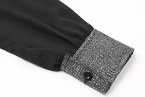 Detailed close-up showing the sequin stitched sleeve cuff and button on a black fashion dress