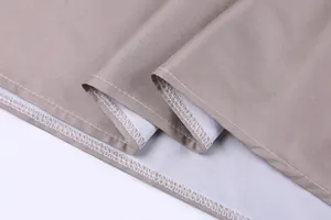 Close-up of the professional stitching and durable fabric hem on a brown dress