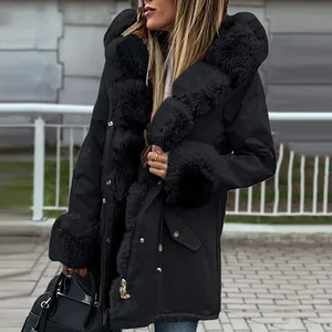 Detailed view of women's black hooded parka with thick faux fur collar and cuffs