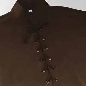 Close-up detail of medieval tunic featuring lace-up front and textured brown fabric.