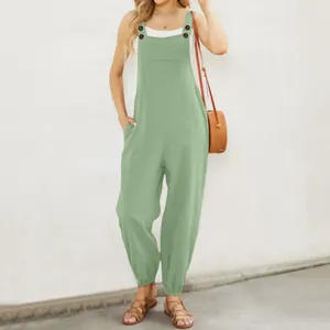 Full view of a mint green cotton linen jumpsuit with buttons and pockets