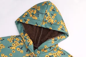 Close-up of floral hooded jacket showing soft brown fleece lining and button detail.