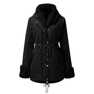 Front view of a black women's hooded parka with faux fur collar and drawstring waist details.
