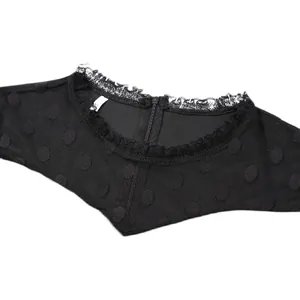 Detailed view of a black polka dot mesh dress featuring delicate lace trim and neckline