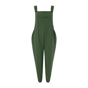 Front view of a dark green linen jumpsuit with button straps and a chest pocket detail