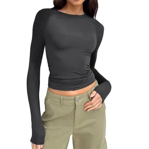 Close-up detail of women's slim fit black raglan long sleeve T-shirt with thumb holes.