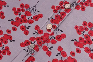 Detailed close-up shot of a grey floral printed cotton coat featuring natural round wooden buttons