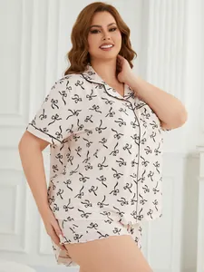 Comfortable plus size women's pink pajama set with stylish black bow print details