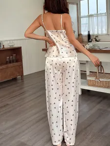 Elegante set pigiama in raso bianco con stampa a fiocchi, top e pantaloni da donna