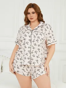 Plus size women's pajama set featuring black bow print and comfortable ruffled shorts