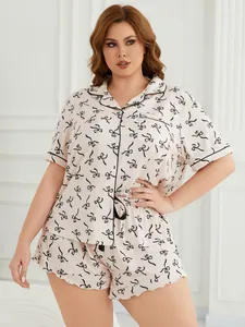 Plus-size women's pajama set featuring short sleeves, shorts, and a charming black bow print.