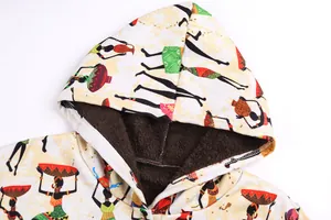 Detail of ethnic print hooded jacket showing thick brown plush lining