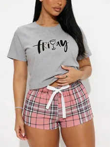 Comfortable women's 2-piece pajama set with Friday print tee and pink plaid shorts