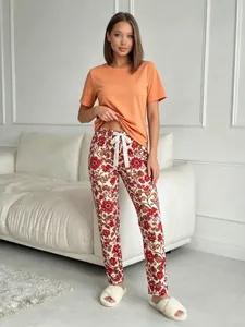 Casual two-piece women's pajama set featuring orange T-shirt and floral print long pants