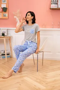 Detail view of women's short-sleeve grey top and blue floral pajama pants lounge set