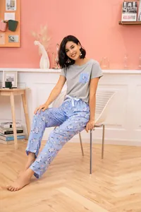 Detailed shot of women's short-sleeve pajama set with blue floral long pants and bow