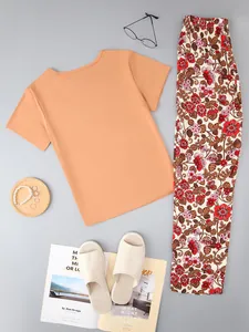 Women's pajama set featuring orange short-sleeve top and floral long pants set