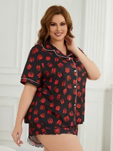 Detailed view of women's plus size pajama set with festive red gift box print on black