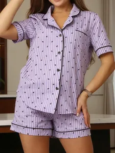 Detail of women's purple striped pajama set with lapel and bird print.
