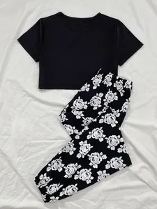 Detail view of black crop top and floral print pajama pants set for women's loungewear
