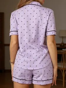 Back view of women's purple striped pajama set with swallow print and black trim