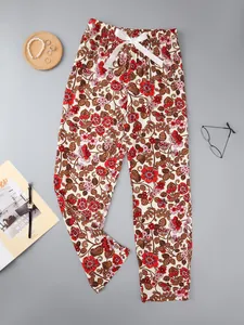 Detailed view of floral print pajama pants featuring red flowers and a white satin bow