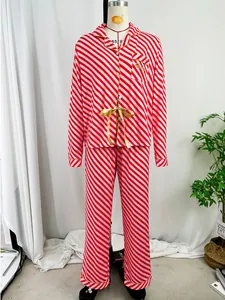 Close-up view of red and pink diagonal striped long-sleeved Christmas pajama set on mannequin