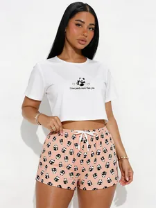 Womens two-piece pajama set with white panda crop top and printed peach shorts