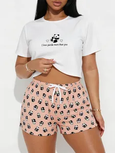 Close-up detail of women's white panda print t-shirt and pink patterned shorts pajama set