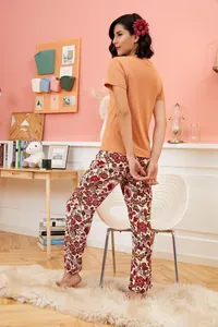 Two-piece casual summer pajamas for women featuring orange short sleeve top and floral pants.
