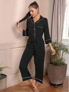 Elegant black women's jumpsuit pajamas with white contrast piping and waist tie