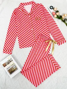 Red and pink striped long-sleeve Christmas pajama set with gold ribbon details