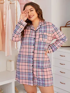 Detail shot of a plus-size pink plaid long sleeve nightdress in a cozy bedroom setting.
