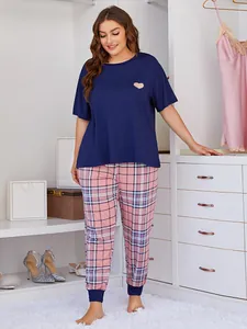 Plus size women's pajama set featuring navy blue heart top and pink plaid joggers