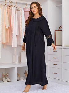 Close-up of black plus size nightgown featuring elegant lace details on sleeves
