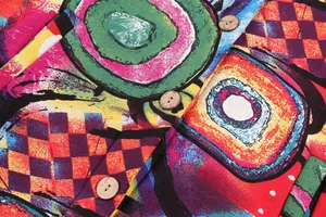 Close-up view of the vibrant abstract pattern fabric and vintage style wooden buttons.