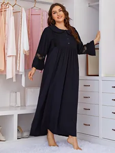 Detailed view of a plus size long black lace-trimmed nightgown in a closet setting