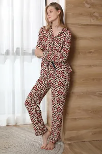 Elegant women's two-piece leopard print pajama set with long-sleeved button-up top.