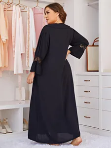 Back view of a plus size long black nightgown with delicate lace sleeve details.