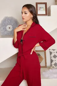 Side view of elegant red long-sleeve jumpsuit loungewear with black piping and belt