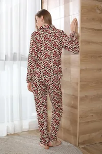 Back view of stylish red leopard print two-piece pajama set for women in cozy home setting