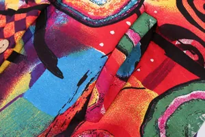 Close-up detail of colorful abstract print plush jacket with pocket and button