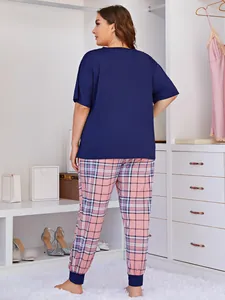 Detailed back view of plus size pajama set with navy top and pink plaid lounge pants.