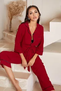 Elegant burgundy long-sleeved one-piece jumpsuit pajamas for women with waist tie detail